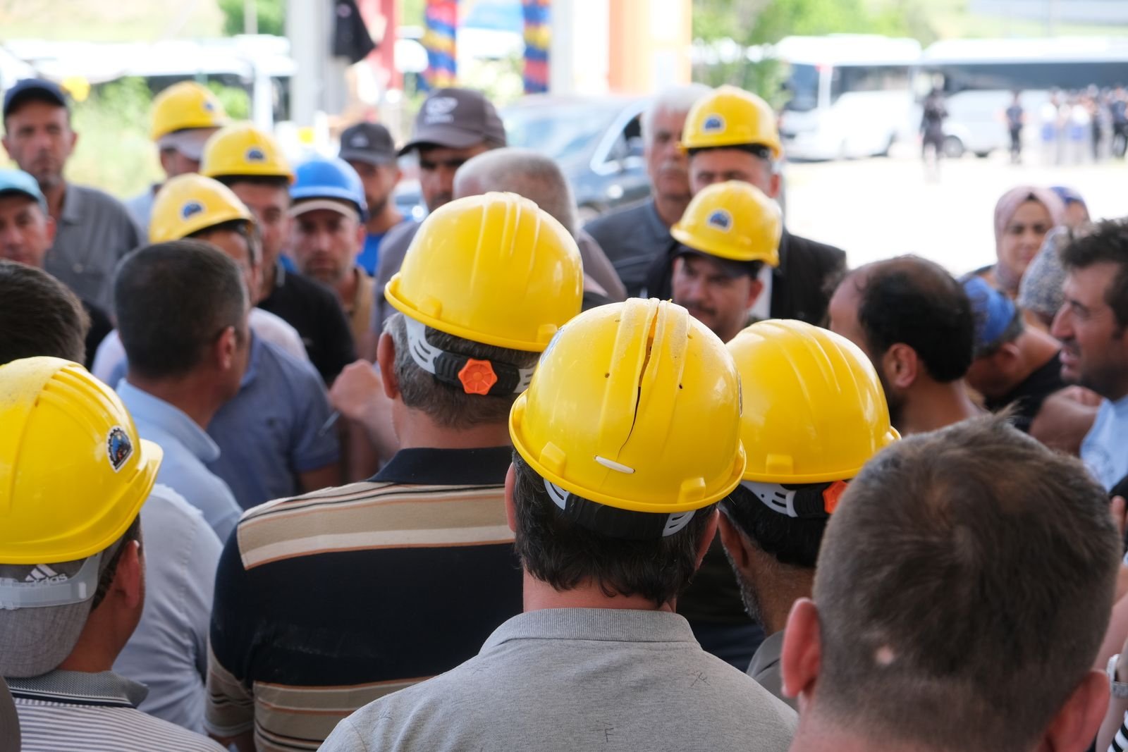 Construction workers in hard hats gathered on a job site.