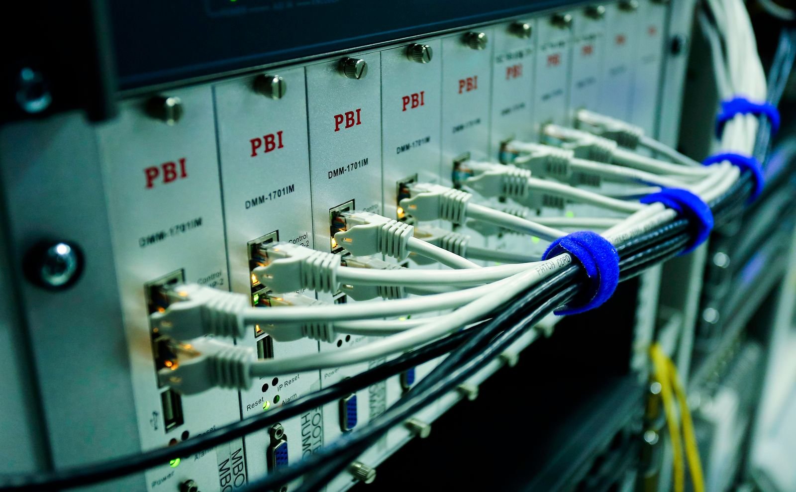 A server rack with labeled network modules and bundled ethernet patch cords.