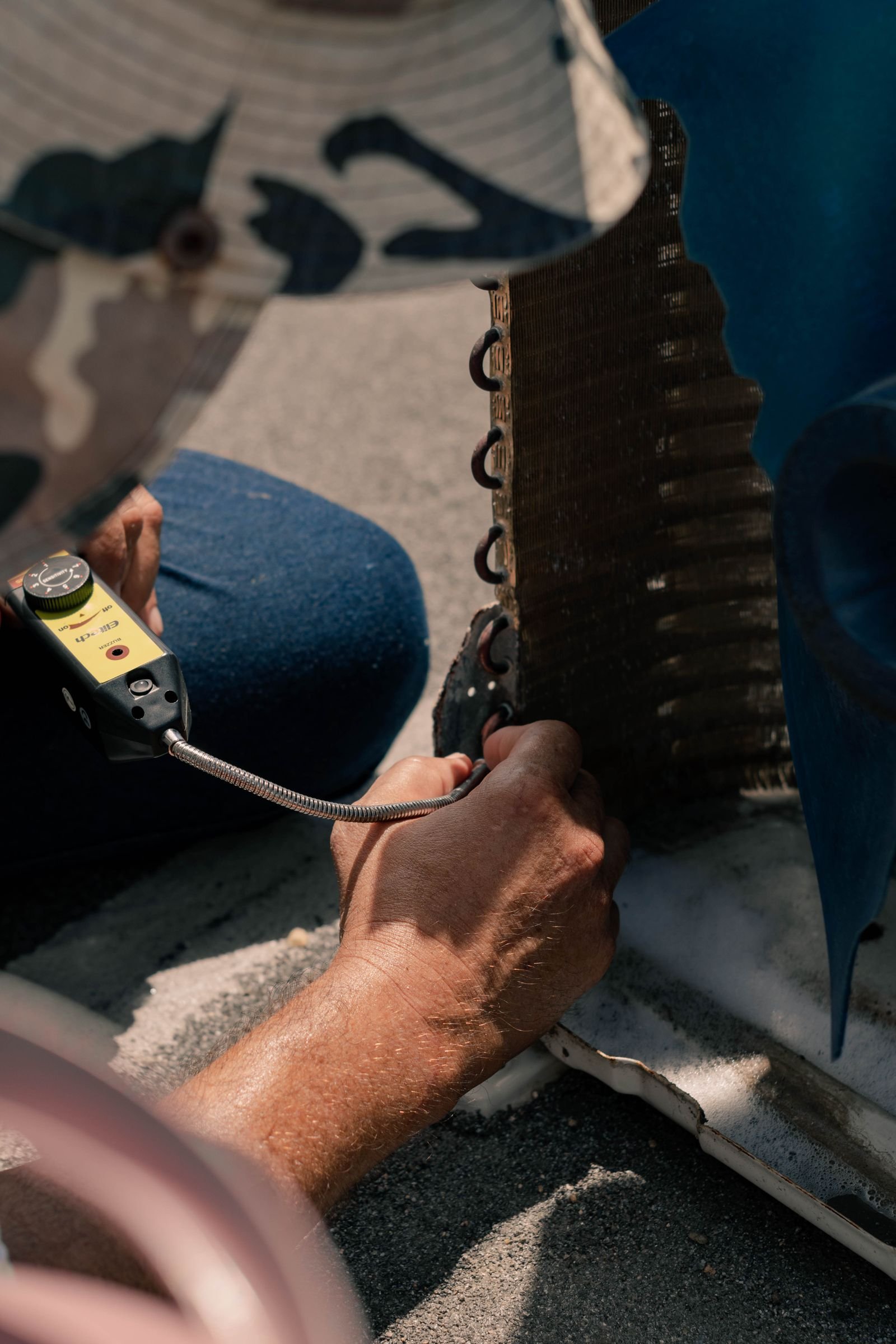 Technician repairing a hotel air conditioning unit.