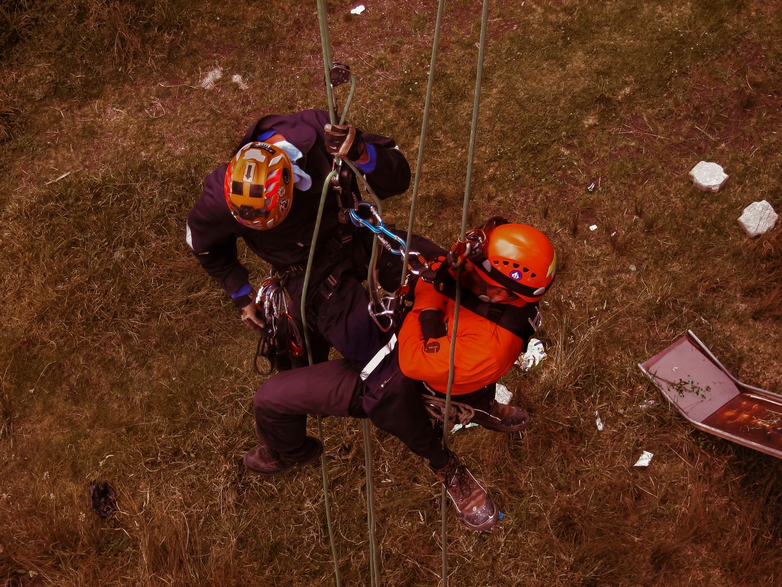 Two rope-access technicians in harnesses during a height-safety training exercise.